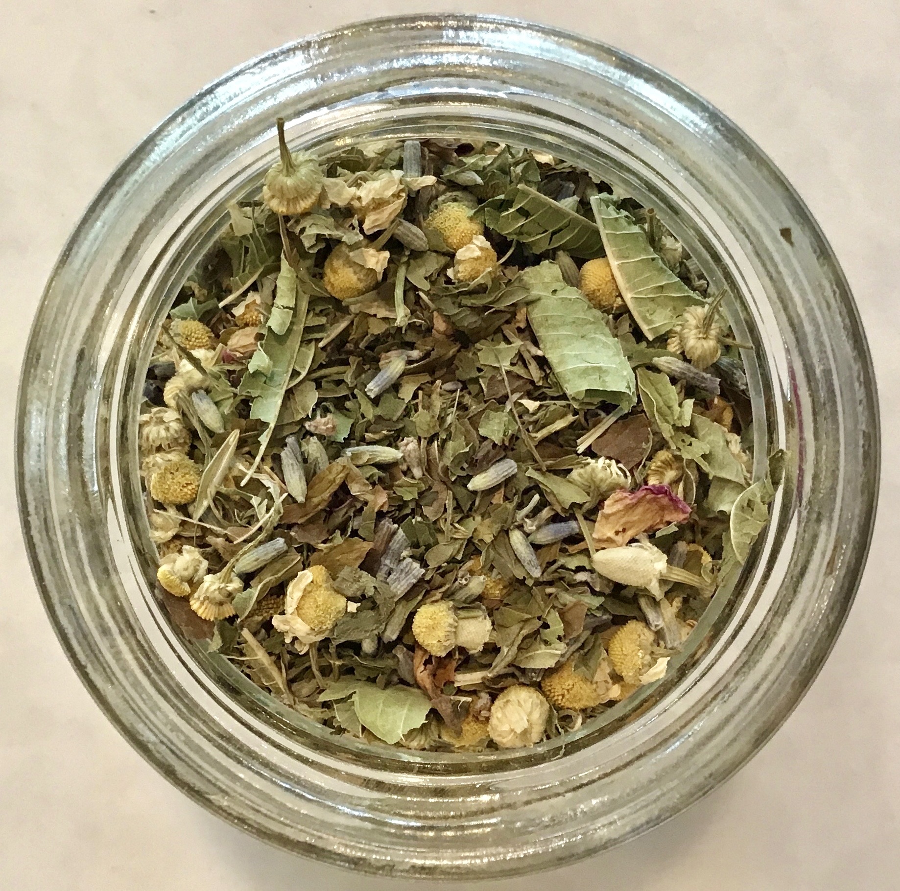 Loose-leaf tea, apothecary-style herbs, and medicinal mushrooms in glass jars