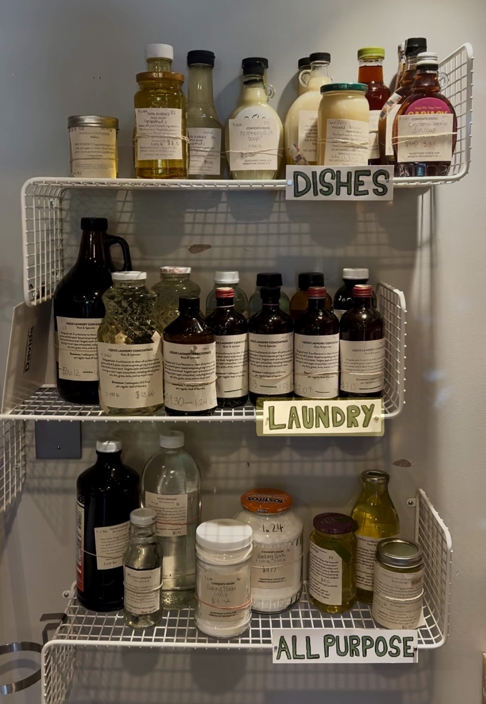 Curated refillable cleaning products in sanitized donated jars on the Essentials shelf