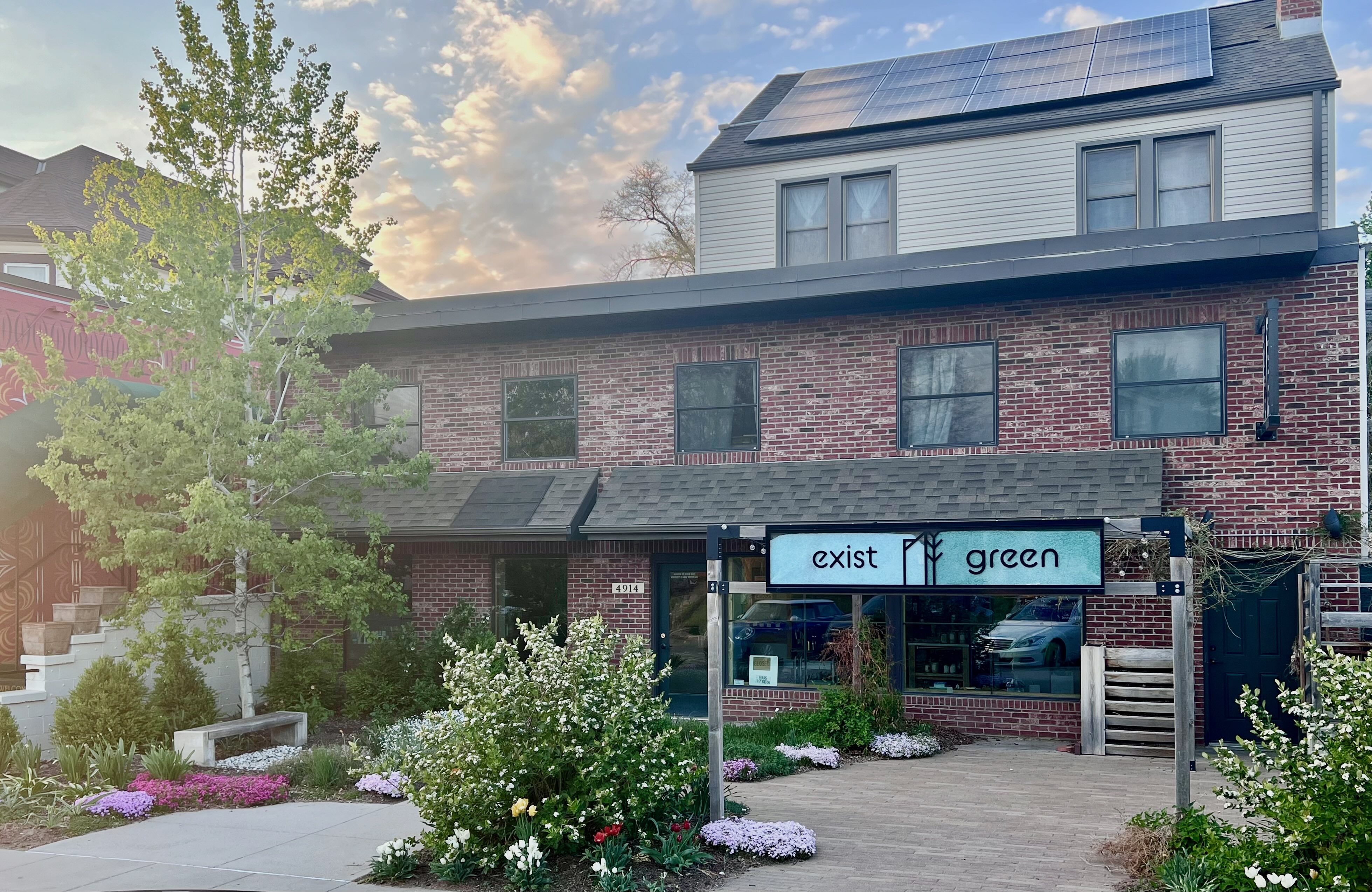 Exist Green storefront with solar panels and garden