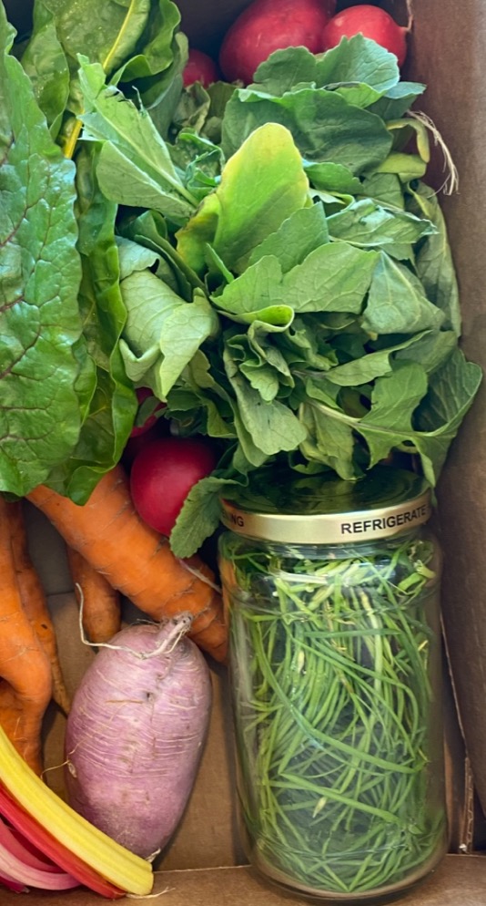 Loose vegetables in reused jars and boxes